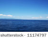 Perfect Blue Sea with coast on horizon